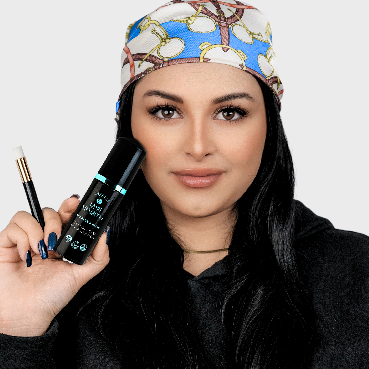 model holding Bubbles & Blink Lash Shampoo is vegan, cruelty-free, and safe for daily use.